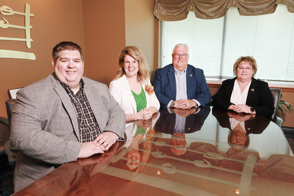 Abacus rises 30 spots on this year's list. Pictured, from left, are company employees John Helms, Andrea Battaglia, Bill Dunton and Teri Wingo.